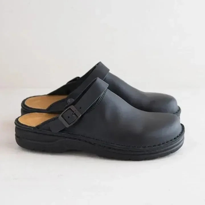 Side angle of men's orthopedic slip-on comfort clogs showing arch support and cushioning