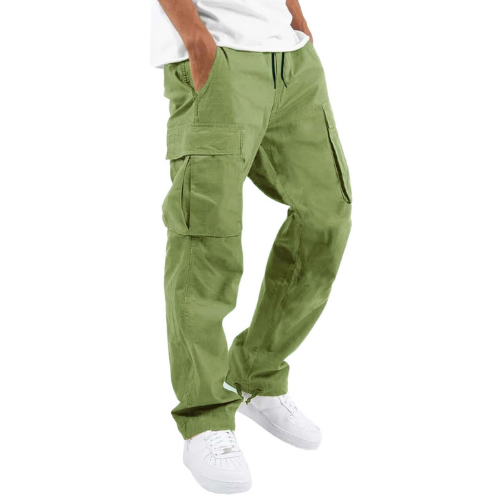 Man wearing olive green cargo joggers with white sneakers