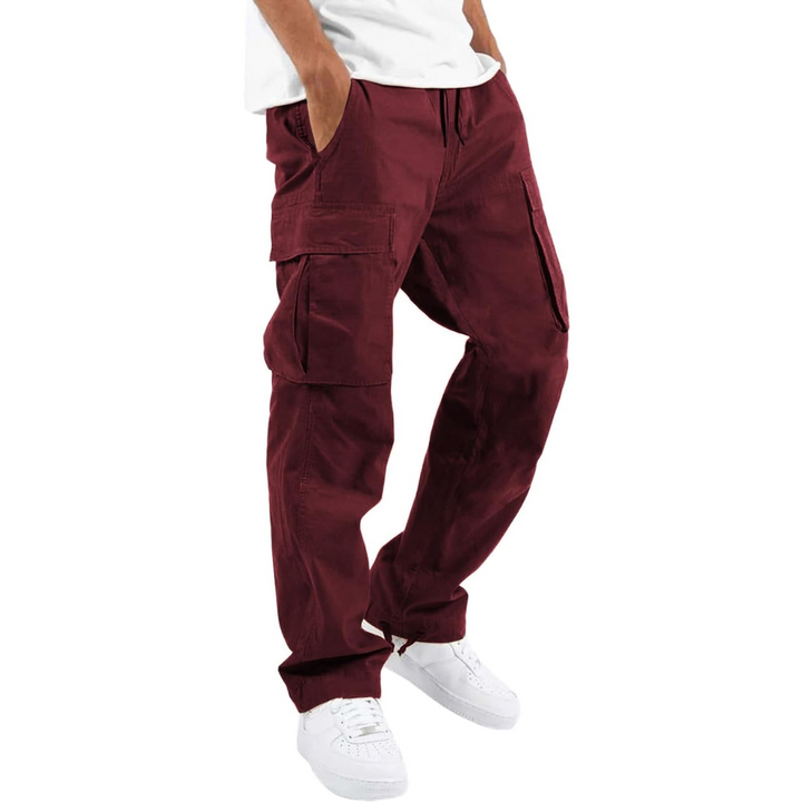 Man wearing red cargo joggers with white sneakers