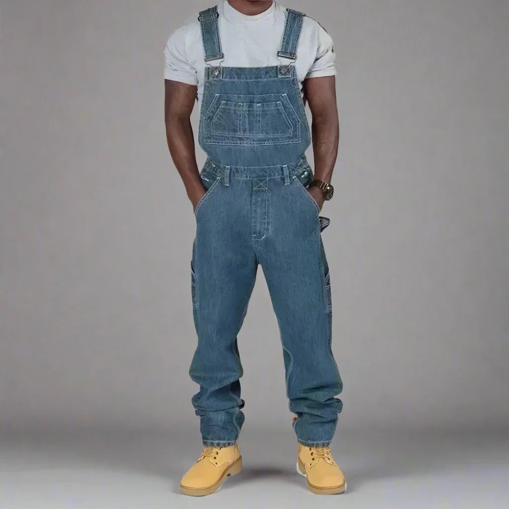 Mens straight leg denim overalls featuring unique splice details and streetwear style.