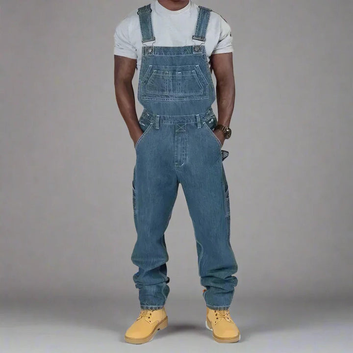 Mens straight leg denim overalls featuring unique splice details and streetwear style.