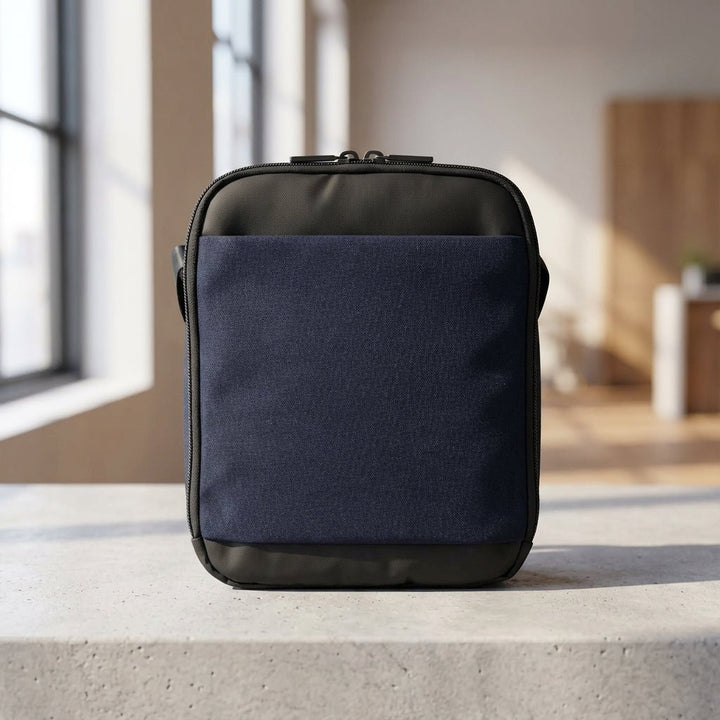 Blue men's compact travel messenger bag viewed from the front