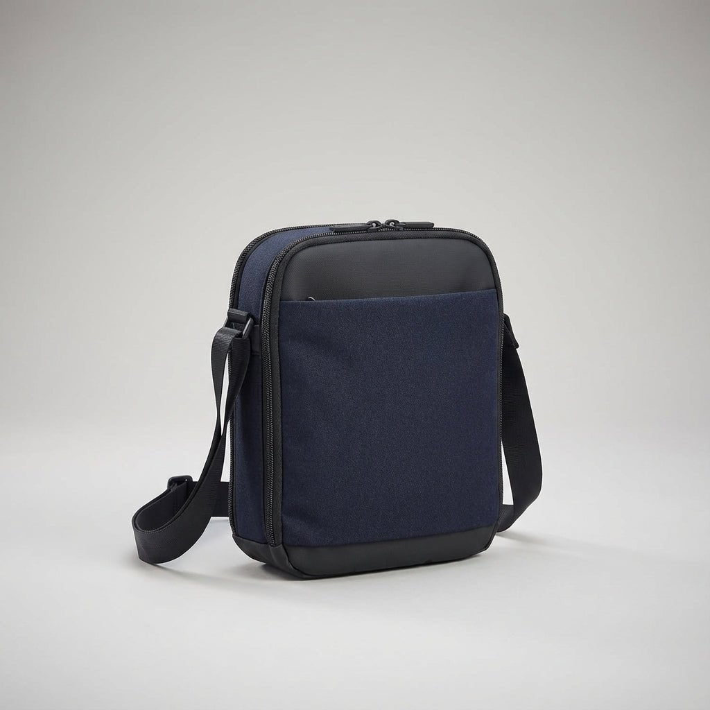 Blue crossbody messenger bag angled to show side profile and zippers