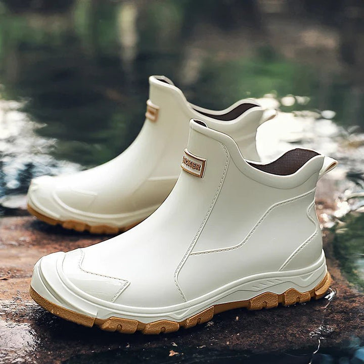 Men's beige waterproof ankle boots displayed in a natural outdoor setting
