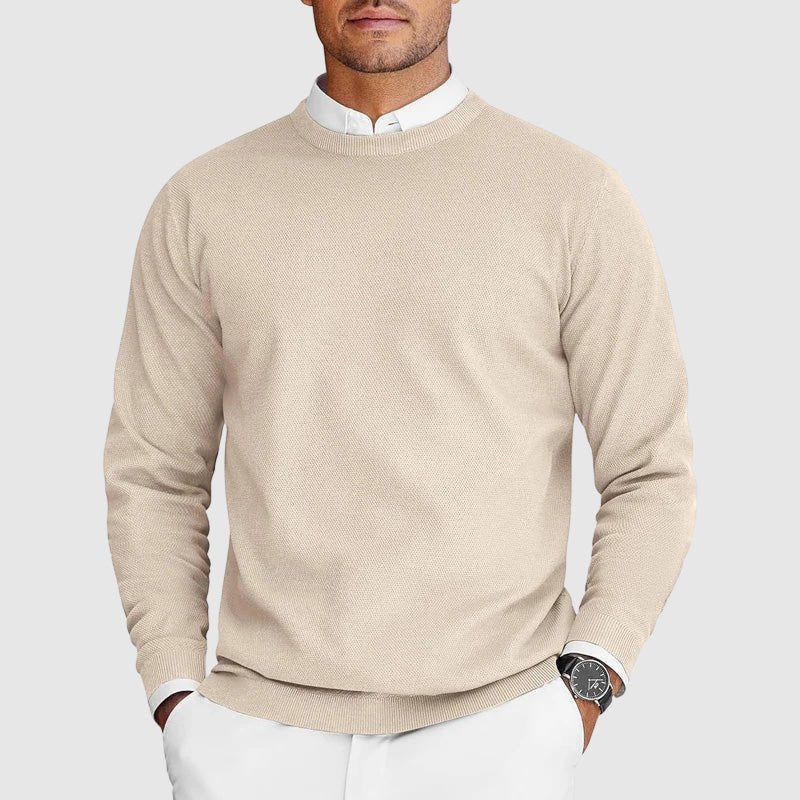 Man wearing beige men's knit sweater with layered white shirt