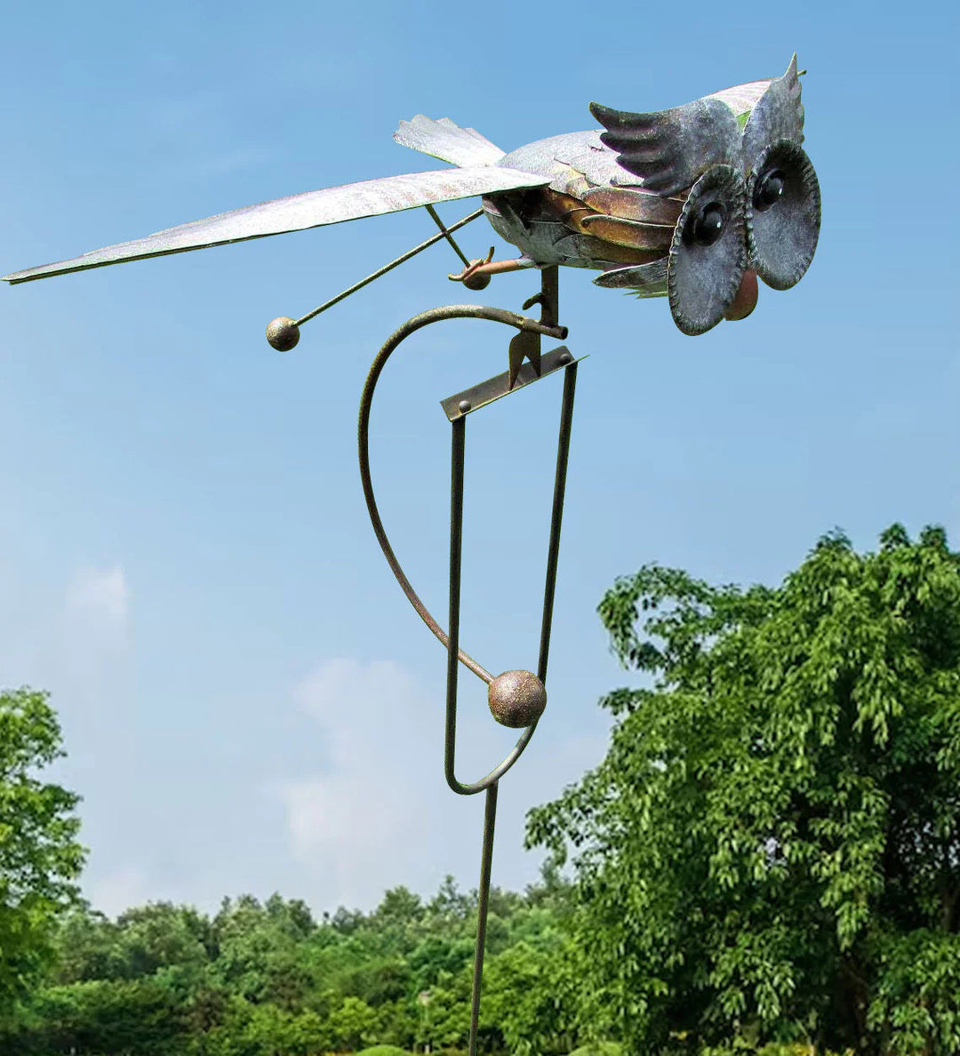 Decorative metal bird wind spinner outdoor sculpture in garden