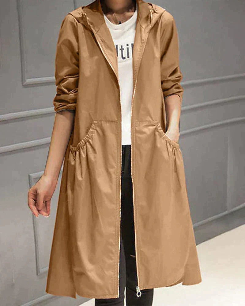 Light brown longline hooded jacket worn by a model against a grey wall