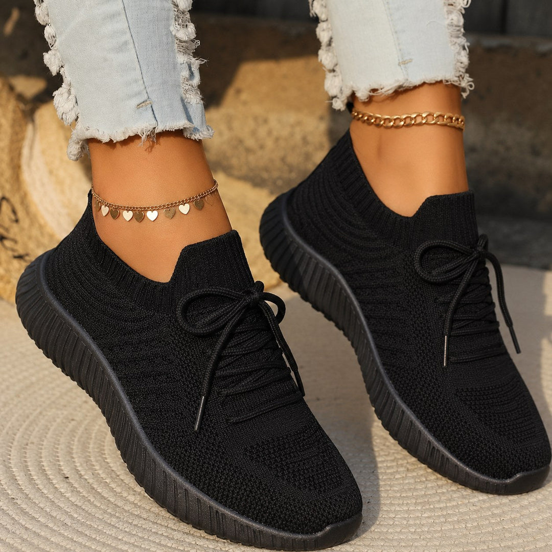Detailed shot of black women's walking trainer featuring a textured knit design