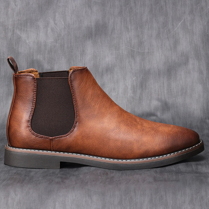 Side profile of Milo men's brown Chelsea boot showcasing the elastic side panel and pull tab