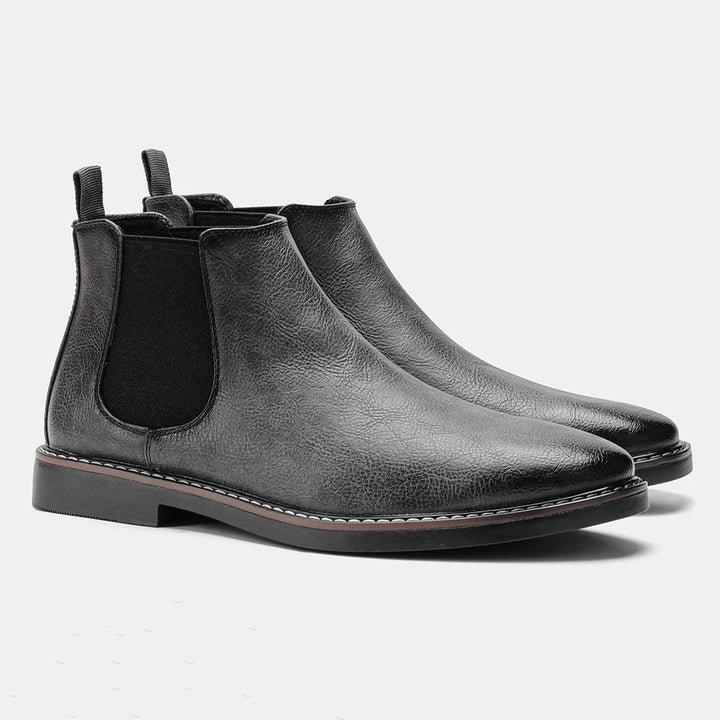 Casual footwear for men showing side profile of pull-on chelsea boots with elastic panels