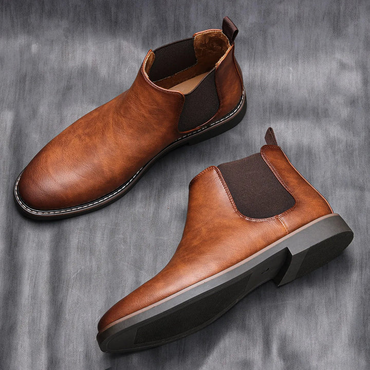 Milo men's brown pull-on Chelsea boots displayed on a grey textured background