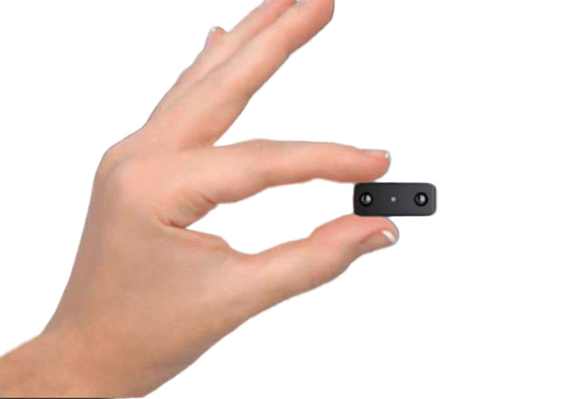 Mini black security camera held between two fingers to demonstrate compact size