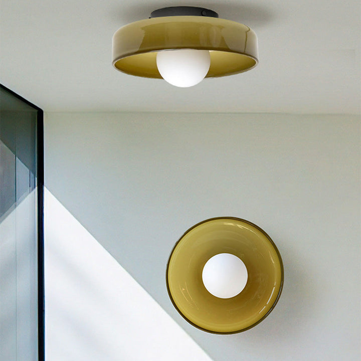 Minimal flush mount ceiling light in olive green mounted on a white ceiling