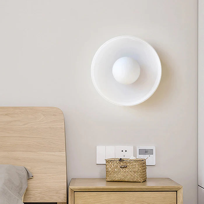 White minimal flush mount ceiling light installed in a modern bedroom setting