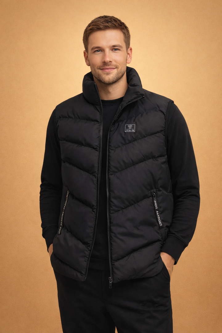 Man wearing a black quilted puffer vest with zipper pockets