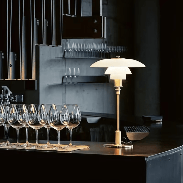 Decorative modern table lamp emitting soft warm LED light in room