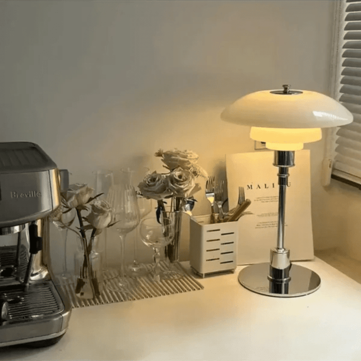White glass shade table lamp illuminating a cozy kitchen counter setup