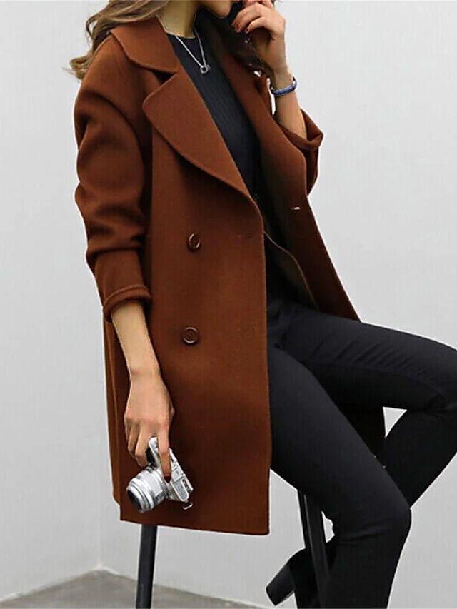 Woman sitting while wearing a brown trench coat