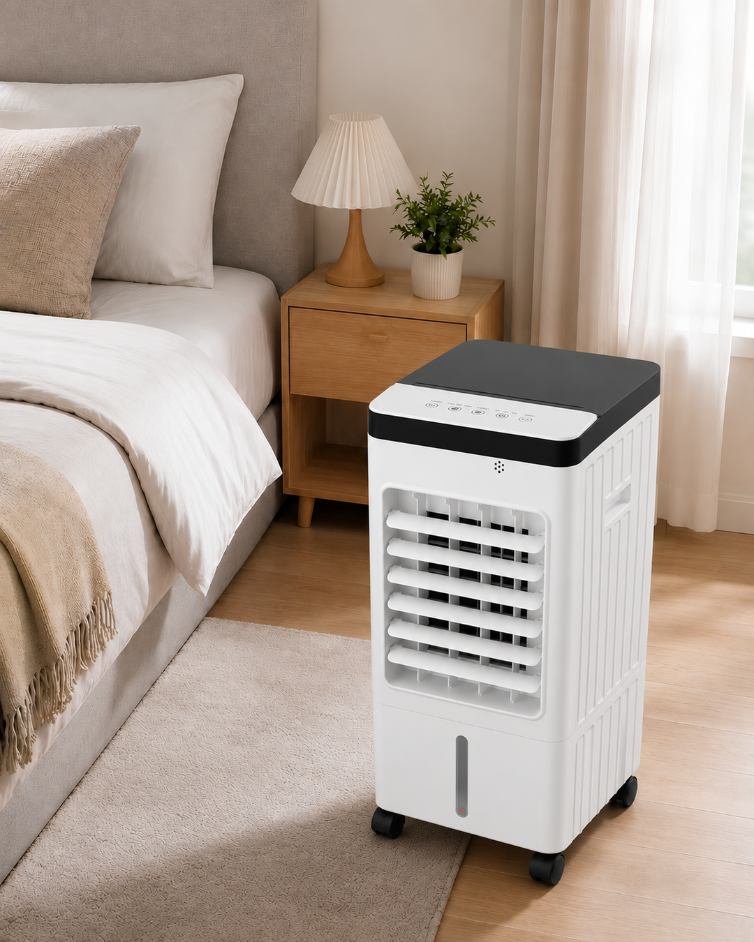 White portable air conditioner placed next to a modern bedroom bed