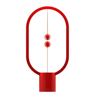 Modern balance table lamp in vibrant red finish against a plain background