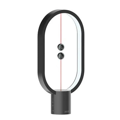 Modern balance table lamp with glowing LED strip and innovative magnetic sphere switch on wooden base.