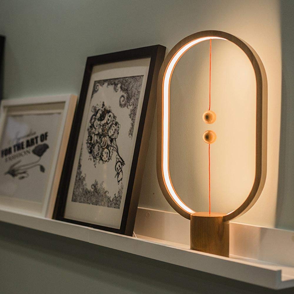 Sleek minimalist bedside lamp emitting warm ambient light, perfect for modern interior design.