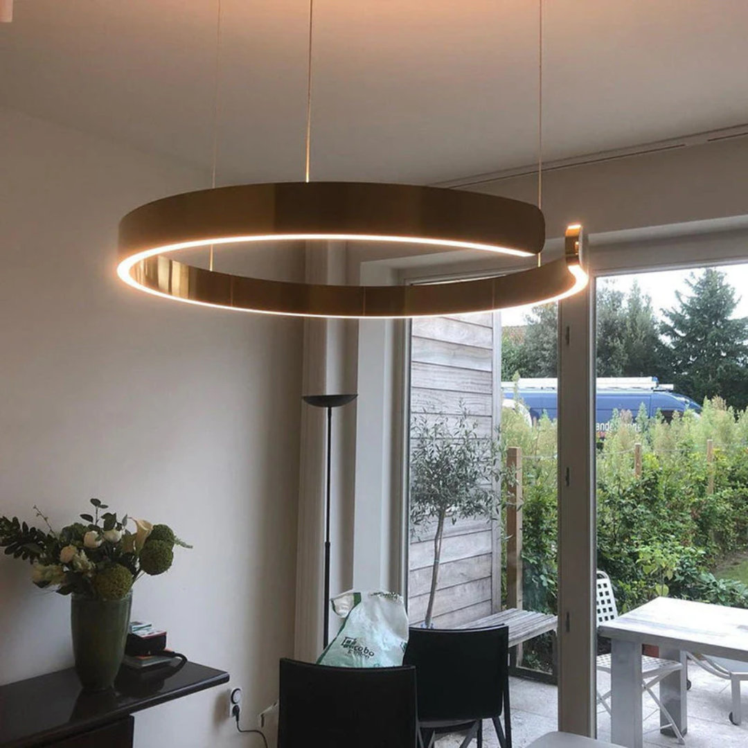 Modern Circle LED Pendant Light HaloRing in gold hanging above a dining table