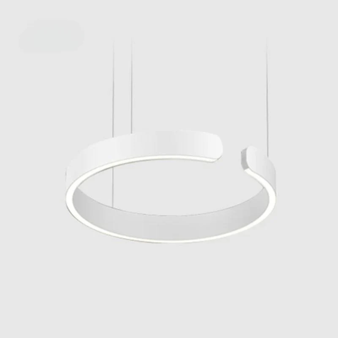 Modern circle LED pendant light hanging over a dining table, showcasing contemporary interior lighting design.