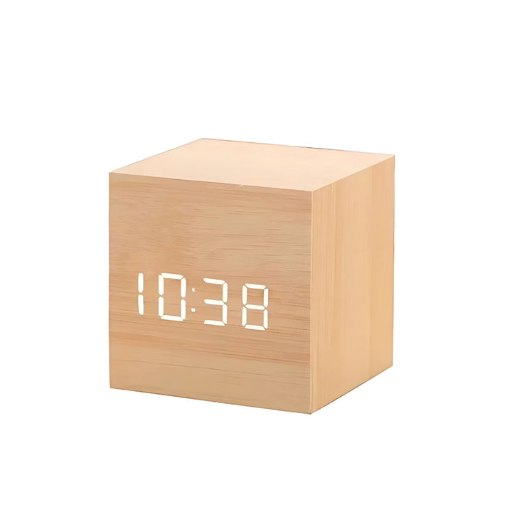 Modern cube LED alarm clock displaying digital time on wooden desk