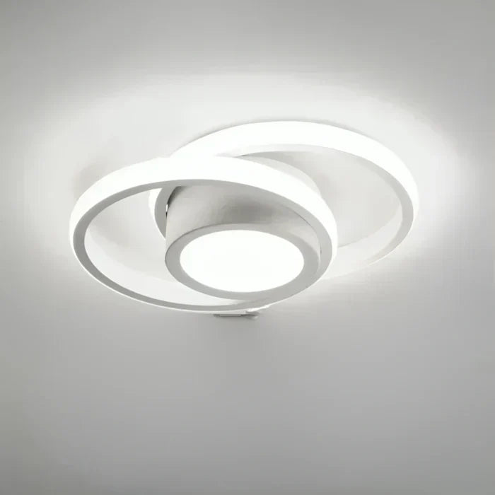 Round white modern LED ceiling lamp mounted on a white ceiling
