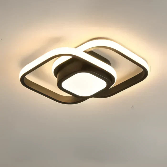 Illuminated modern LED ceiling lamp mounted on a white living room ceiling