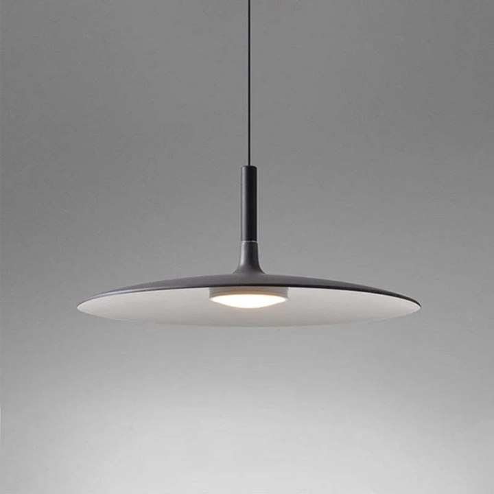 Minimalist light fixture casting a soft glow, perfect for modern home decor and interior styling.