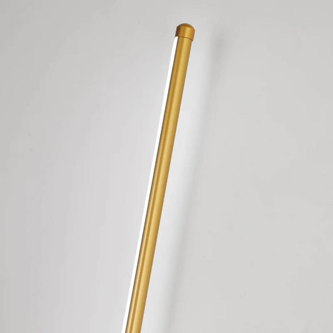 Close-up view of the gold cylindrical LED wall light fixture