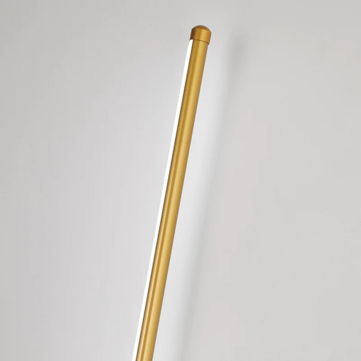 Close-up view of the gold cylindrical LED wall light fixture