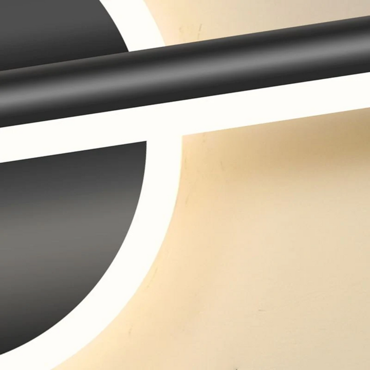 Close-up of the gold and black modern LED wall light fixture