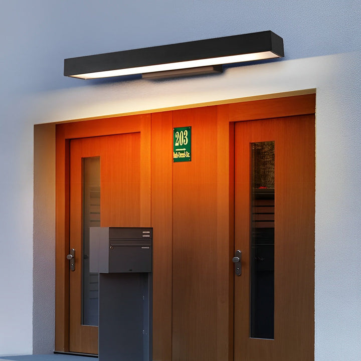Sleek outdoor LED wall light illuminating a wooden double front door entrance