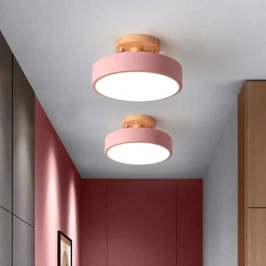 Modern round LED ceiling light illuminated in a contemporary dining space