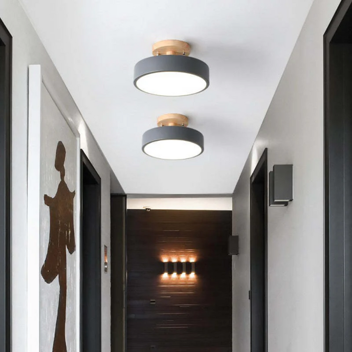 Decorative interior lighting fixture casting a wide beam of ambient light