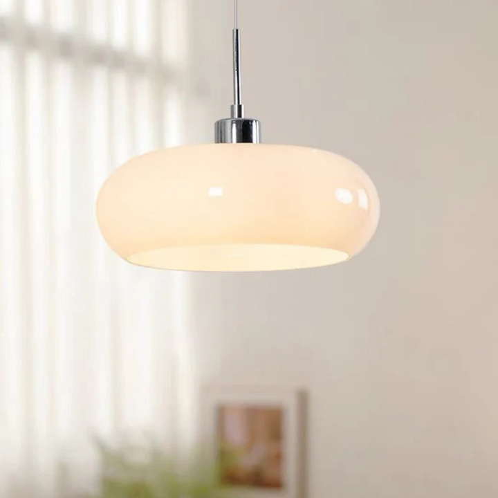 Elegant white round LED pendant light against a sheer curtain background