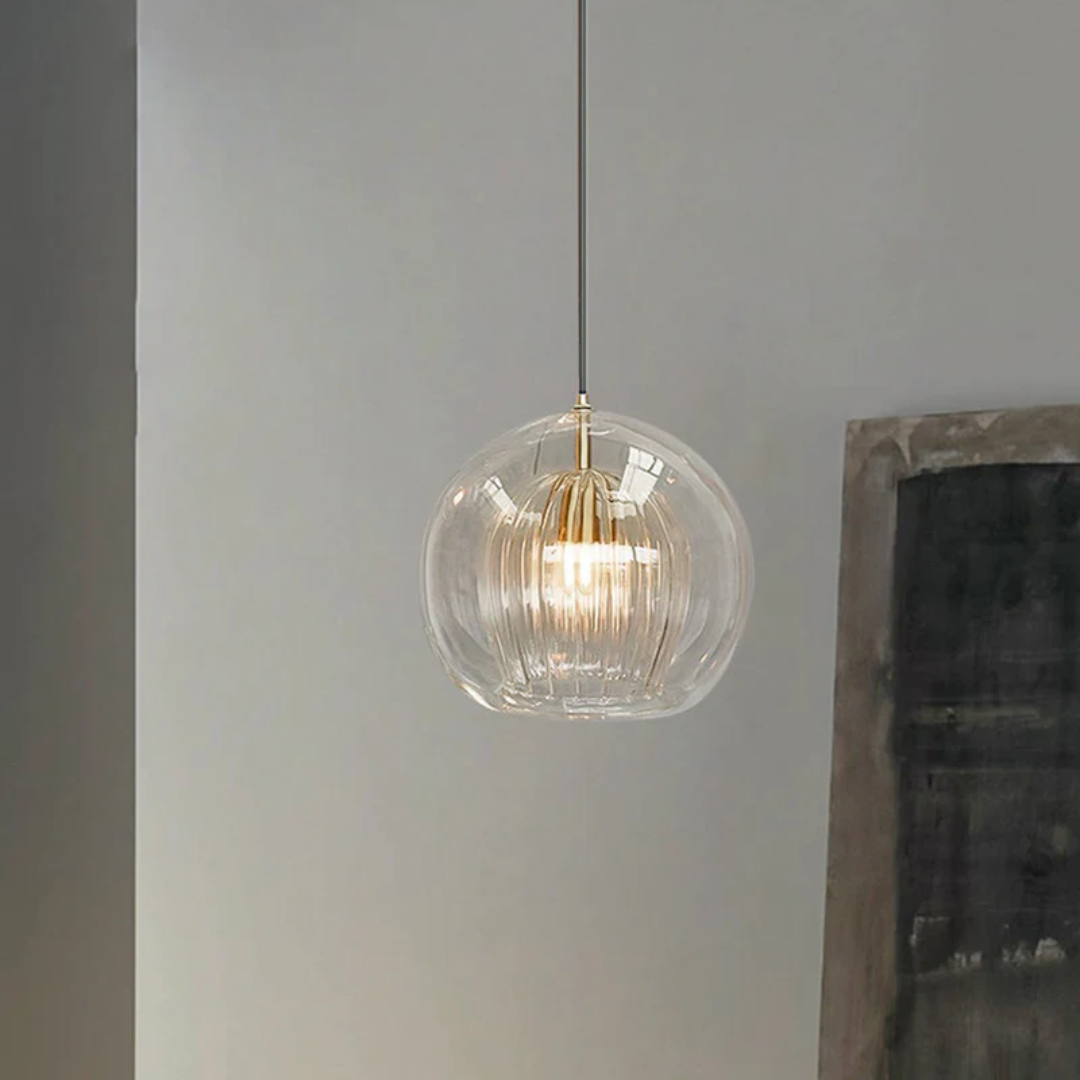 Detailed view of the metallic suspension hardware and amber glass globe