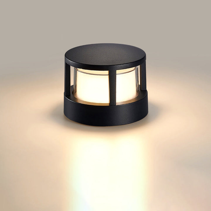 Architectural garden light illuminating driveway entrance with bright LED beam