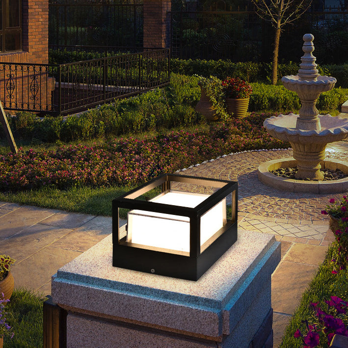Square black aluminium LED outdoor garden light installed on a stone wall pillar
