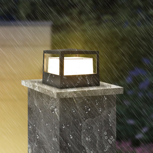 Modern aluminium LED outdoor post light illuminating a garden pathway at night