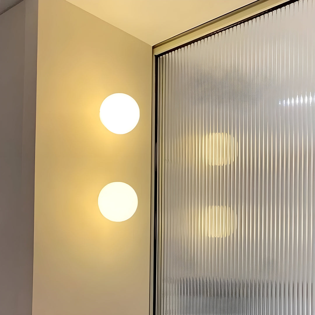 Modern minimalist wall lamp casting warm light in a cozy living room interior