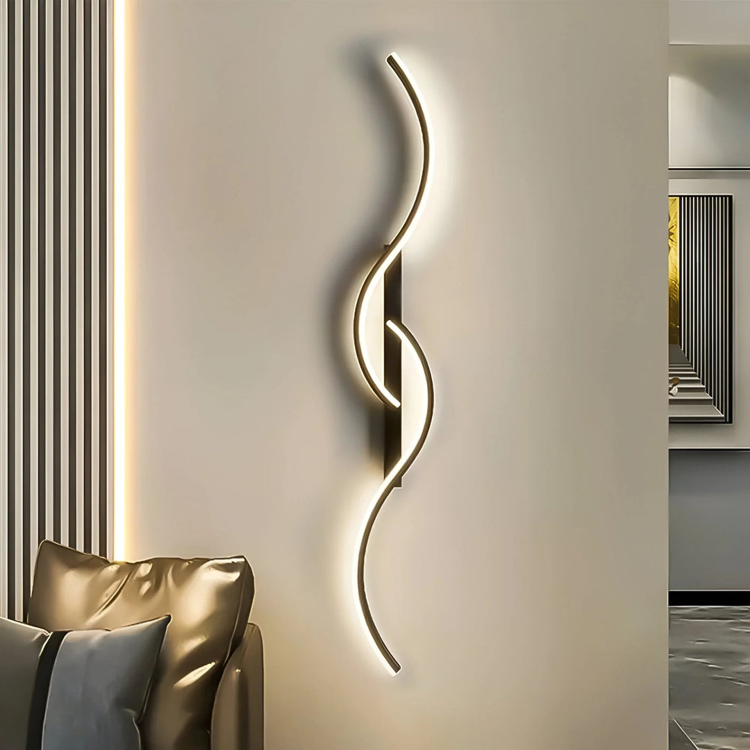 Black modern curved LED wall light mounted on a neutral interior wall