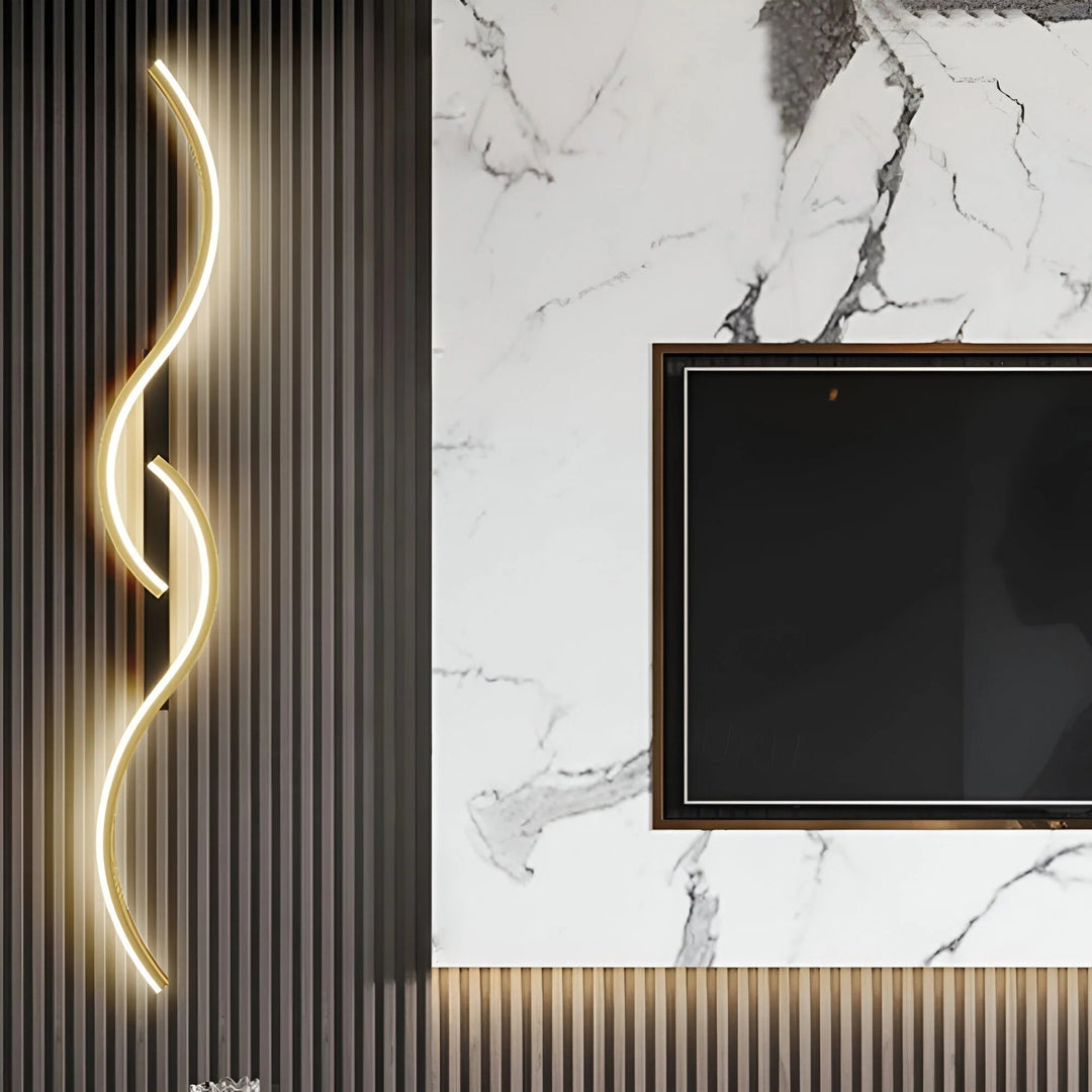 Gold LED wall light sconce illuminated next to a modern TV feature wall