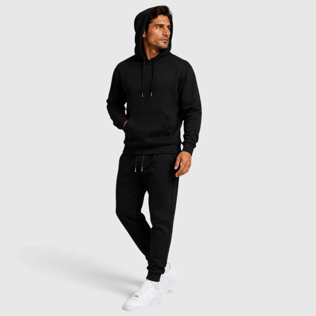 Front view of man in black hoodie and joggers lounge set