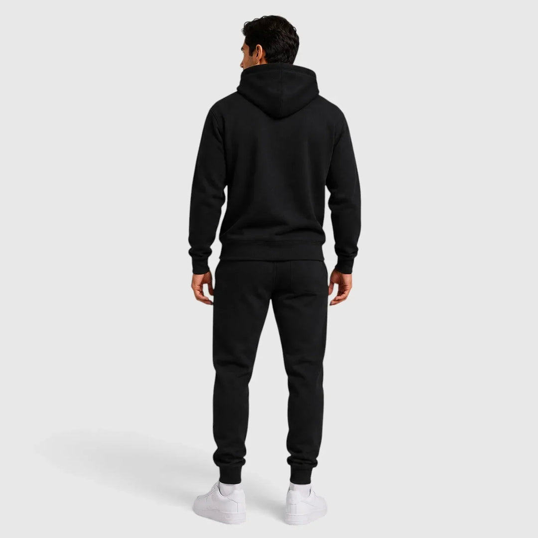 Back view of man wearing black hoodie and joggers lounge set