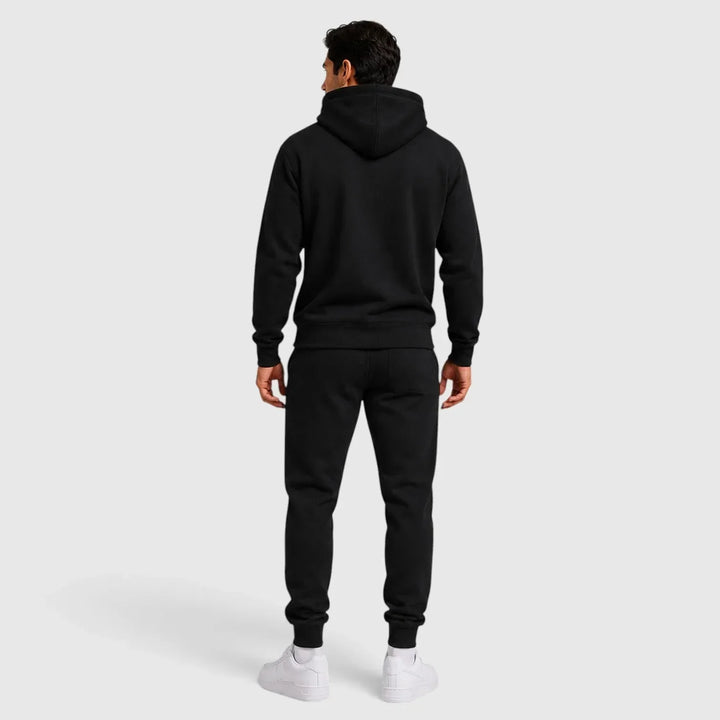 Back view of man wearing black hoodie and joggers lounge set