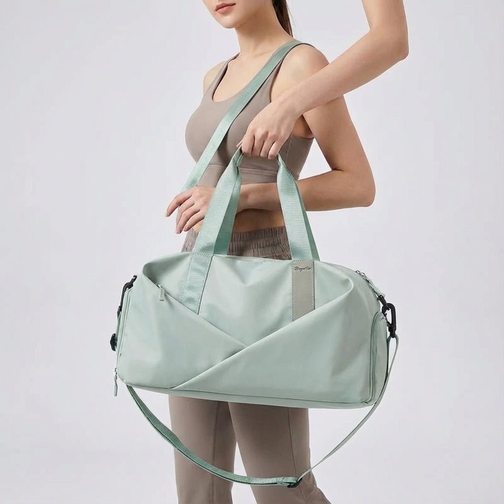 Woman showcasing the green sports duffel bag with adjustable strap